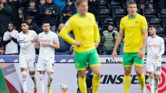 Swansea players celebrate their second goal against Norwich