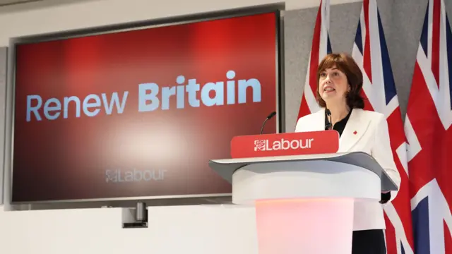 Lucy powell at a lectern