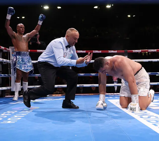 Fabio Wardley with his hands in the air while Justis Huni is on his knees