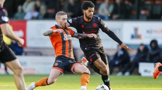Dundee United's Craig Sibbald challenges St Mirren's Miguel Freckleton