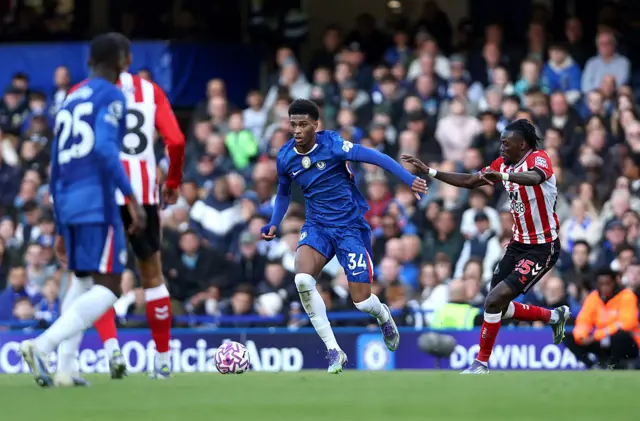 Josh Acheampong of Chelsea is challenged by Bertrand Traore of Sunderland