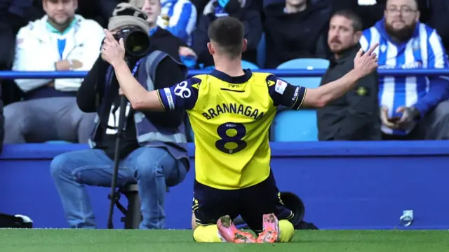 Cameron Brannagan slides on his knees in celebration