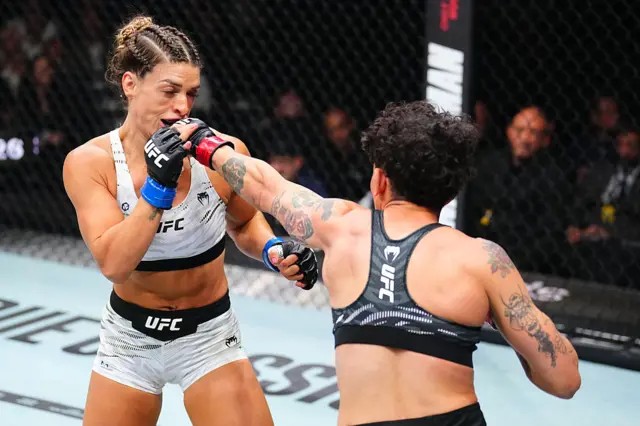 Virna Jandiroba of Brazil punches Mackenzie Dern in the UFC strawweight championship