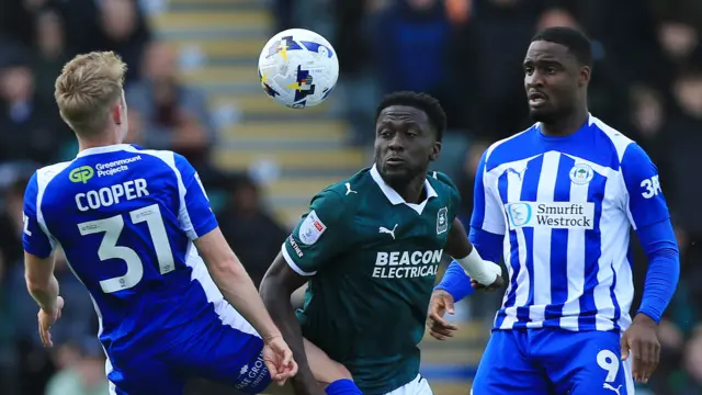 Wigan's Ollie Cooper (L)