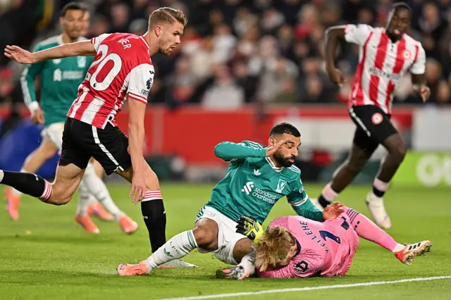 Mohamed Salah of Liverpool collides with Caoimhin Kelleher of Brentford