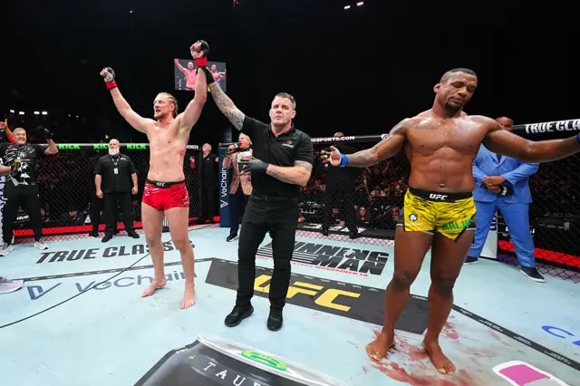 Volkov has his hand raised as the decision is read out