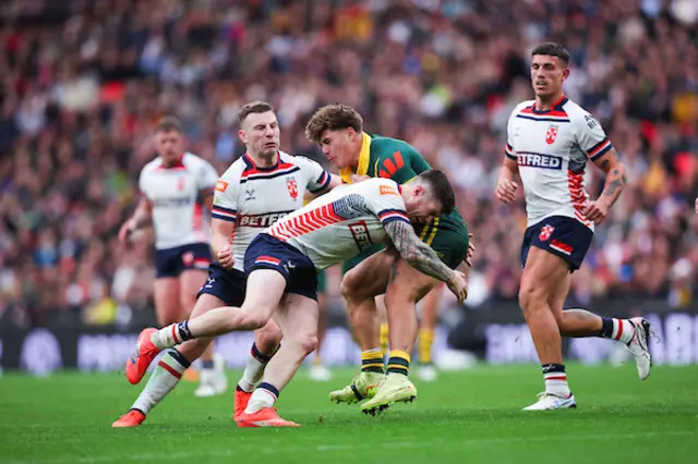 Reece Walsh of Australia is tackled by John Bateman of England