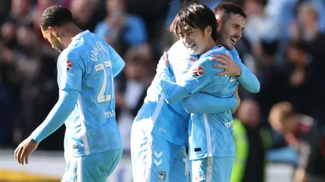 Tatsuhiro Sakamoto receives a hug after putting Coventry 3-0 up against Watford