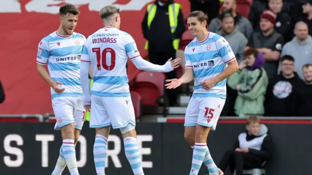 Wrexham players celebrate with goalscorer Josh Windass