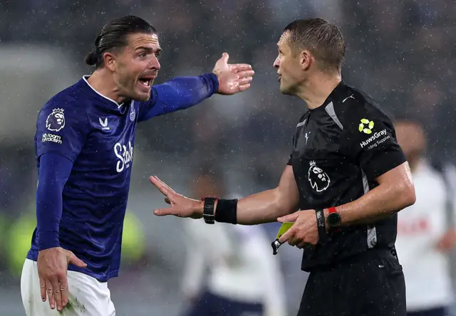 Jack Grealish of Everton clashes with Referee Craig Pawson after receiving a yellow card during the Premier League match between Everton and Tottenham Hotspur at Hill Dickinson Stadium on October 26, 2025 in Liverpool, England.