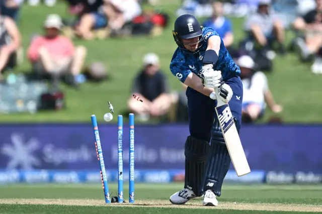 Jamie Smith being bowled.