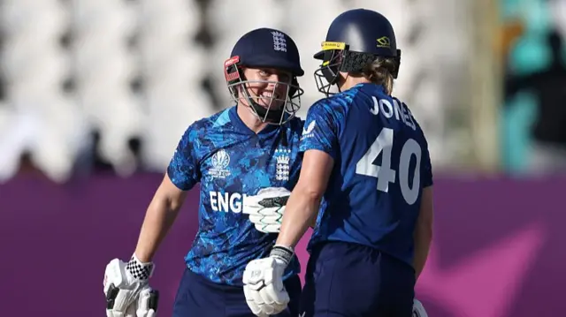 Heather Knight of England (L) laughs with team mate Amy Jones (
