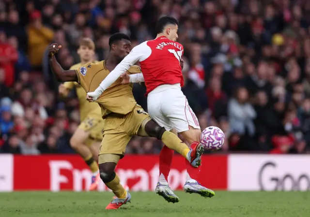 Arsenal's Gabriel Martinelli in action with Crystal Palace's Marc Guehi