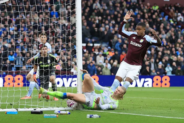 Erling Haaland collides with the post at Villa Park.