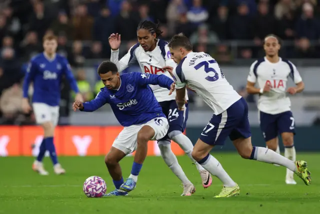 Everton's Iliman Ndiaye in action with Tottenham Hotspur's Djed Spence and Micky van de Ven
