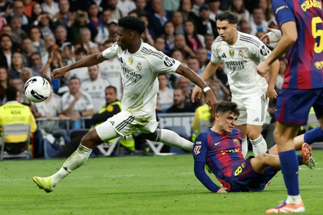 Real Madrid's Aurelien Tchouameni (L) in action agianst against Barcelona's Pedro Gonzalez