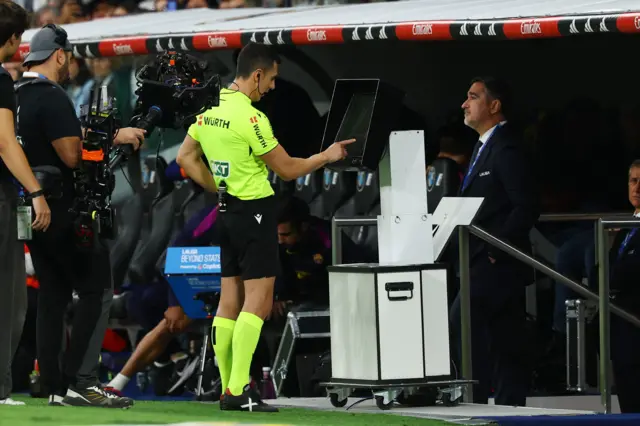 Referee checks monitor at El Clasico