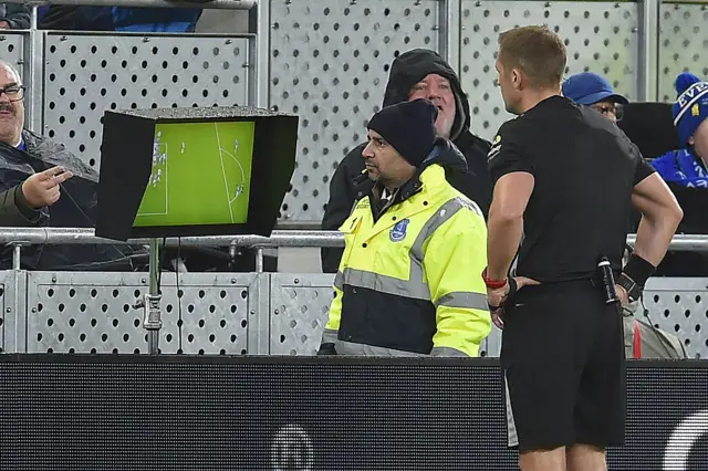 nglish referee Craig Pawson consults the pitch-side monitor before disallowing an Everton goal during the English Premier League football match between Everton and Tottenham Hotspur at Hill Dickinson Stadium in Liverpool, north west England on October 26, 2025.