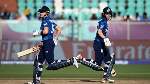 Amy Jones of England (R) runs between the wickets with team mate Heather Knight (L)