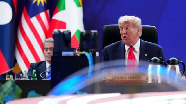 Donald Trump with Scott Bessent in background