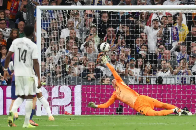 Barcelona's Polish goalkeeper #25 Wojciech Szczesny saves a shot from the penalty spot by Real Madrid's French forward #10 Kylian Mbappe