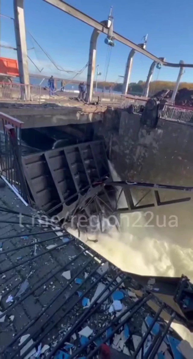 Water gushing through a breach in the dam