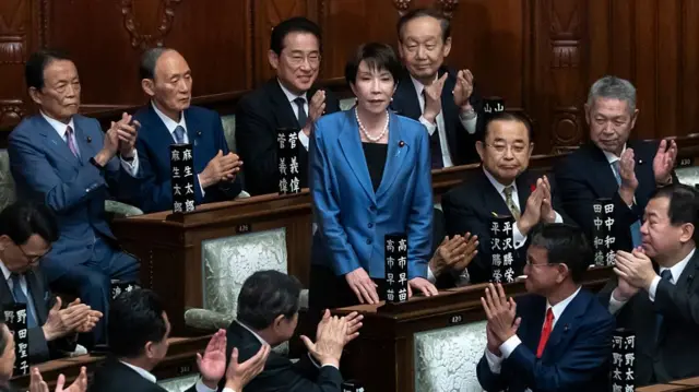 Members of Japan's parliament applaud Sanae Takaichi