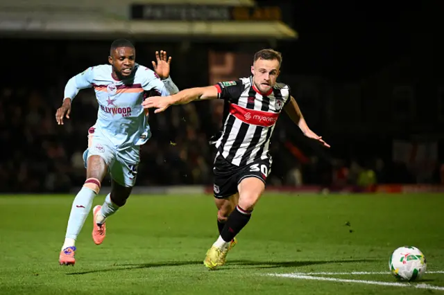 Charles Vernam of Grimsby Town battles for possession with Dango Ouattara