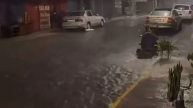 A flooded street as rain pours down