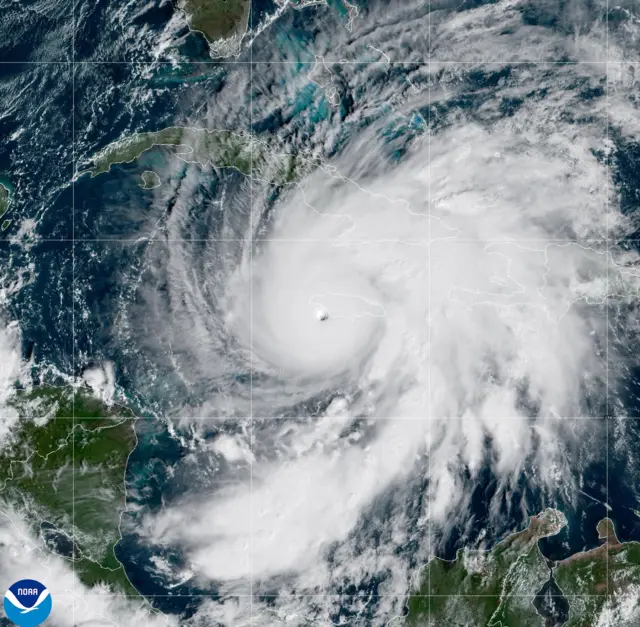 A handout satellite image made available by the National Oceanic and Atmospheric Administration (NOAA) shows Category 5 Hurricane Melissa approaching Jamaica,