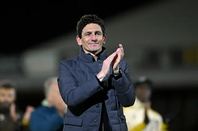 Keith Andrews, Manager of Brentford, acknowledges the fans
