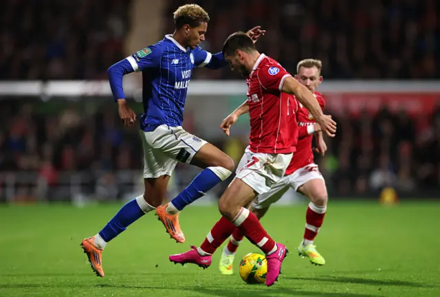 Omari Kellyman of Cardiff City is challenged by Ryan Longman