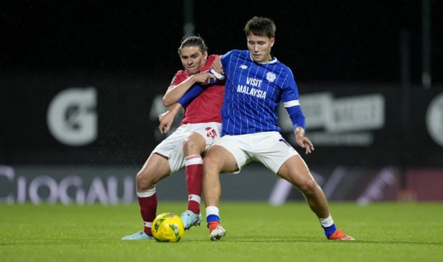 Wrexham's George Dobson and Cardiff City's Rubin Colwill battle for the ball