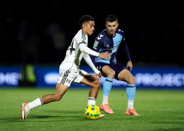 Joshua King of Fulham runs with the ball as Daniel Harvie