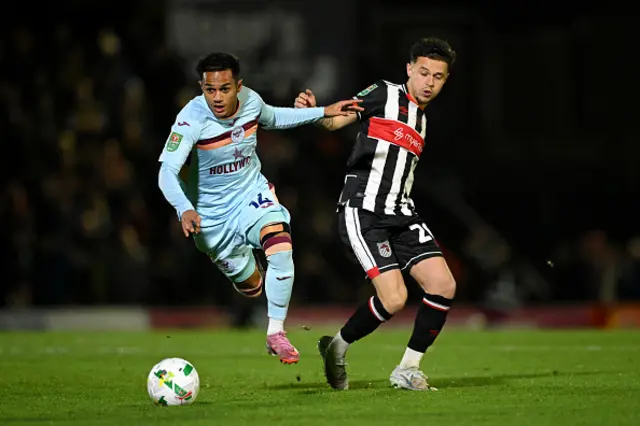 Fabio Carvalho of Brentford is challenged by George McEachran