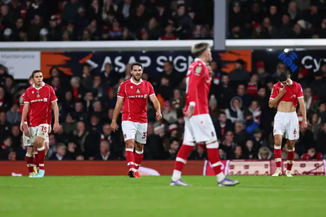 Dejected players of Wrexham look on