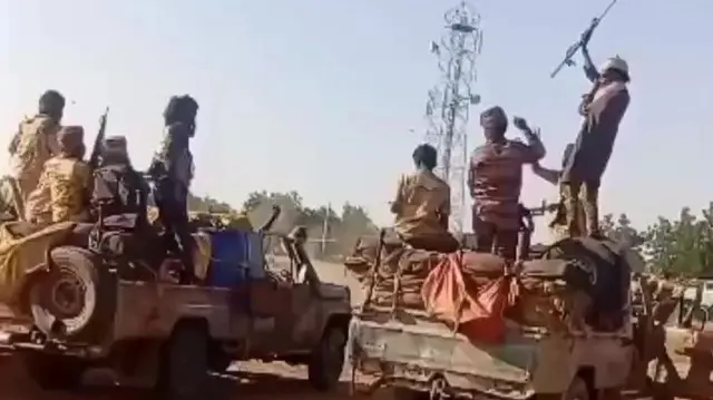 A picture from Sudan shows RSF militia member standing on trucks. some are holding guns