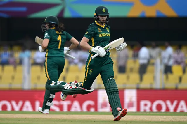 Laura Wolvaardt of South Africa (R) runs between the wicket with team mate Tazmin Brits (L)