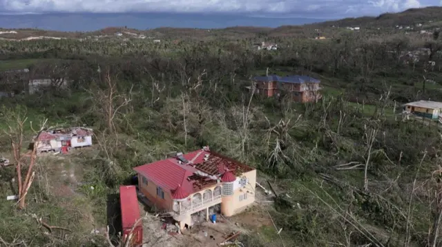 An overhead photo of a building where part of the roof has fallen through