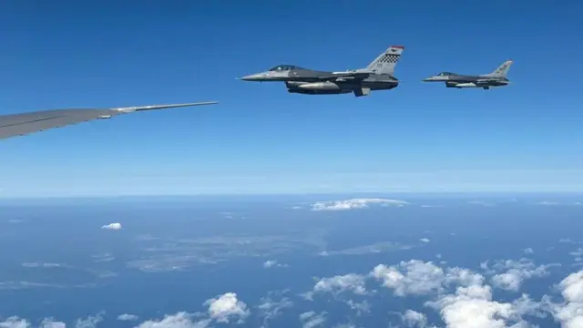 View of fighter jets flying over clouds in the blue sky