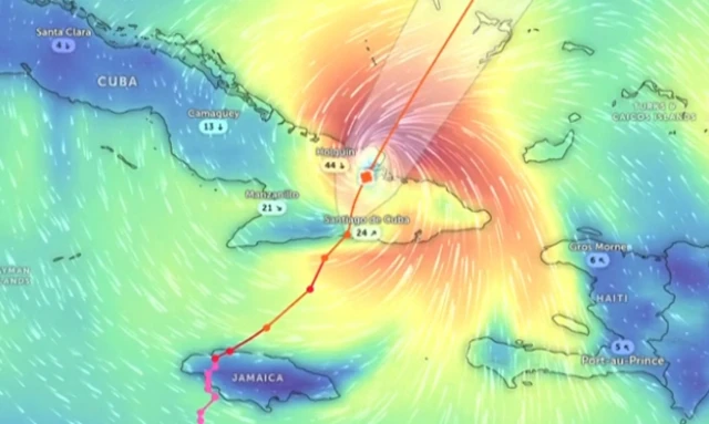 A graphic showing path of Hurricane Melissa, with different colours showing pressure, red over the map of Cuba and blue further out.
