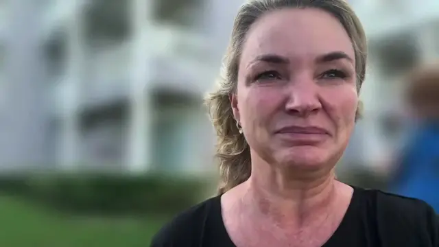 Pia Chevallier holds the camera up towards here while she is speaking to BBC News. The background behind her is blurred