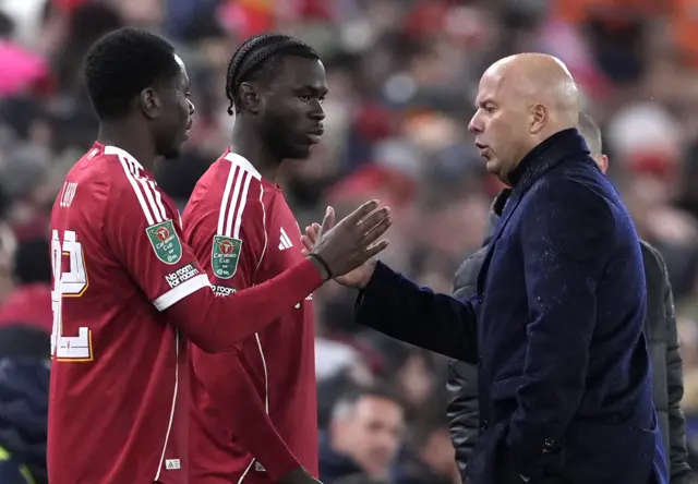 Liverpool's Wellity Lucky and Amara Nallo speak to manager Arne Slot on the touchline