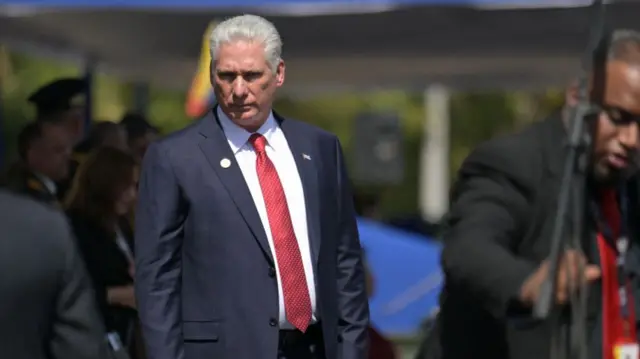 Miguel Díaz-Canel wears a blue suit and red tie
