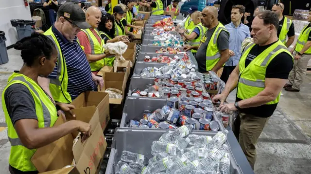 Volunteers fill up boxes with essential goods at the Global Empowerment Mission (GEM) headquarters in Florida, USA on 28 October 2025.