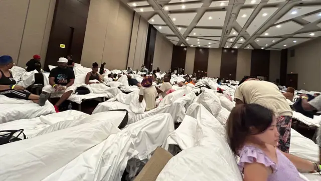People sitting on beds inside a hotel