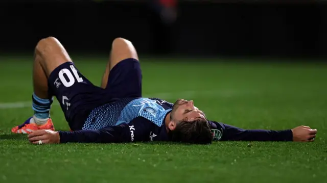 Luke Leahy of Wycombe Wanderers lies on the ground