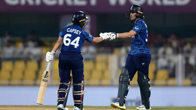 : Alice Capsey of England touches gloves with team mate Nat Sciver-Brunt