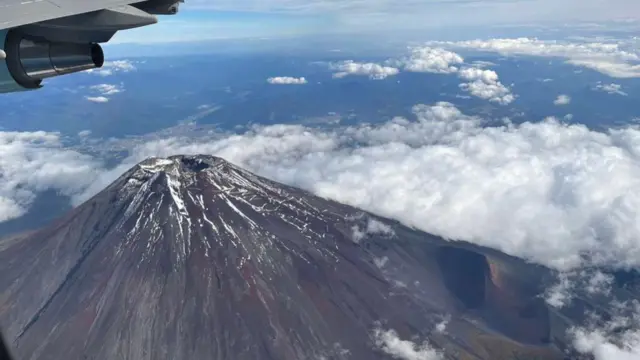 Aerial view of Mount Fuji, surrounded by clouds