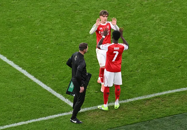 Max Dowman of Arsenal shakes hands with Bukayo Saka as he leaves the field